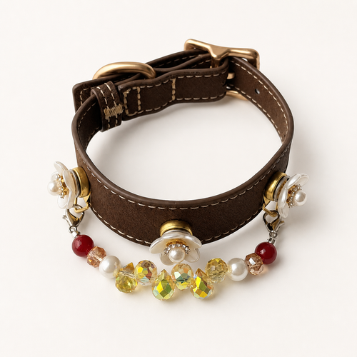 Brown dog collar with three white floral charms and a red, pearl and yellow bead strand
