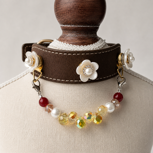 Brown floral dog collar displayed on a cream stand with detachable multicolor bead strand