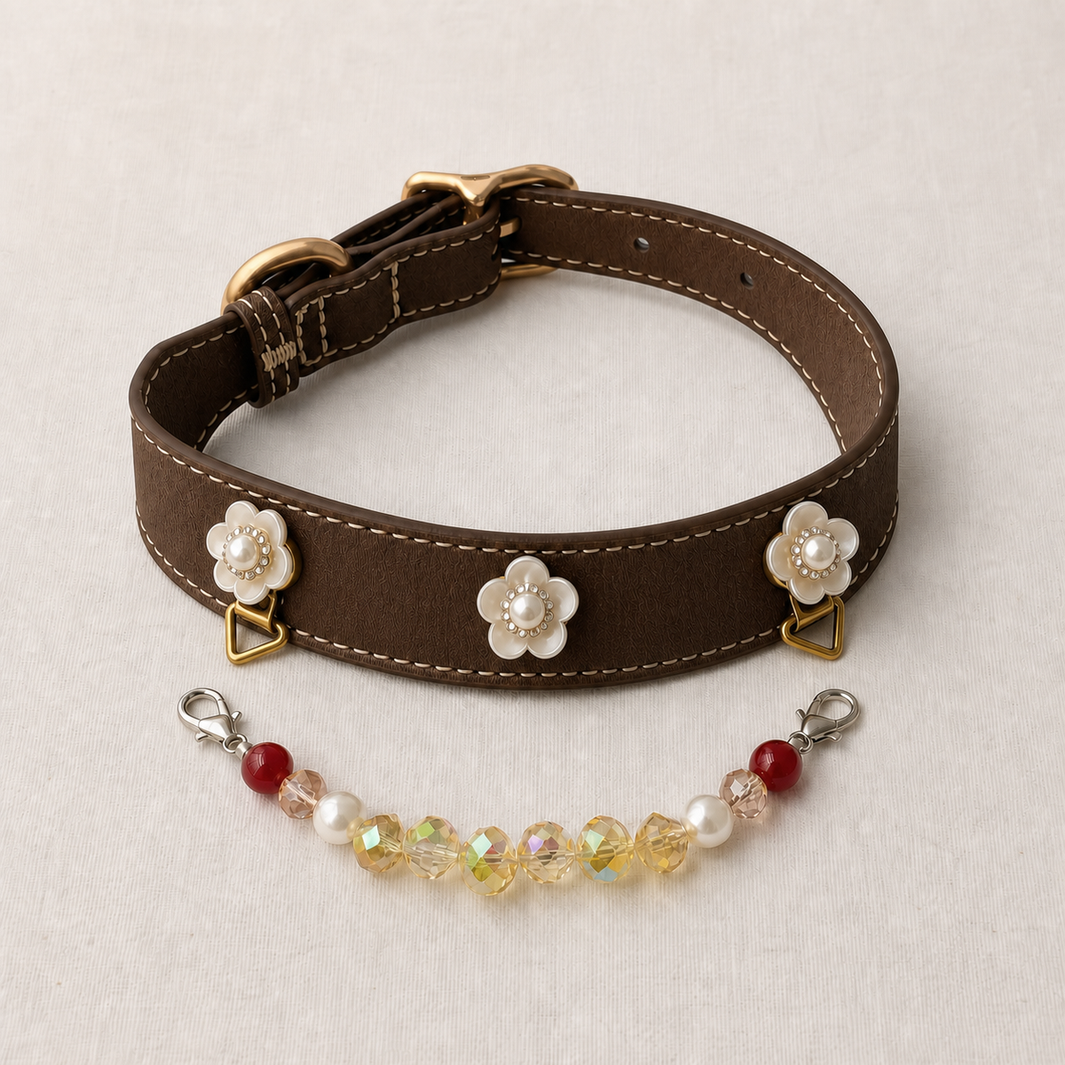 Brown floral dog collar shown with the red, pearl and yellow bead strand detached