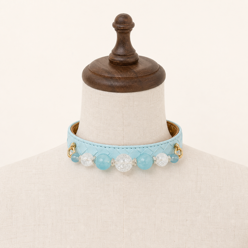 Aqua basketweave beaded dog collar displayed on a cream stand