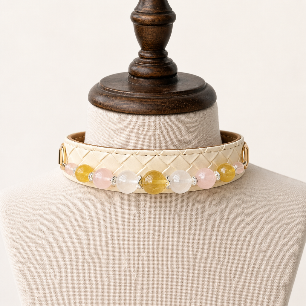 Ivory beaded dog collar displayed around a cream fabric stand
