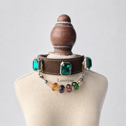 Brown green crystal charm dog collar displayed on a cream Lumiyue stand
