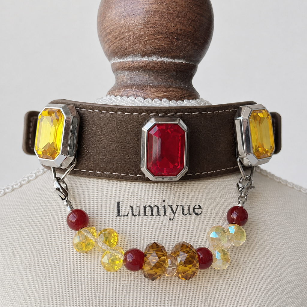 Close-up of red and yellow rectangular charms and multicolor bead strand on brown collar