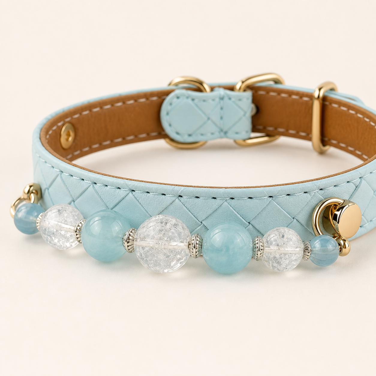 Close-up of aqua basketweave collar, clear and blue beads, and gold-tone fastener