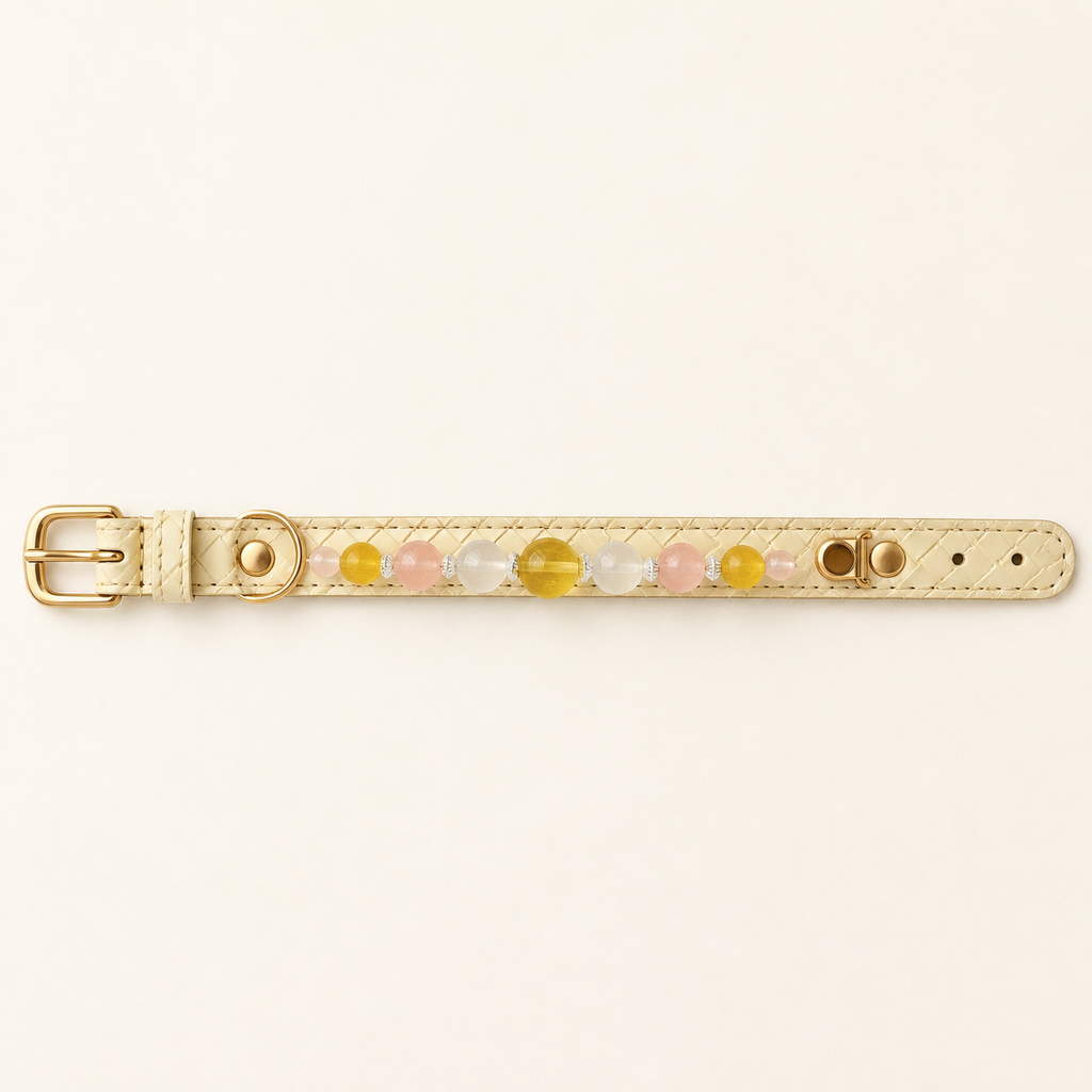 Ivory basketweave dog collar laid flat with buckle, D-ring, adjustment holes and nine beads
